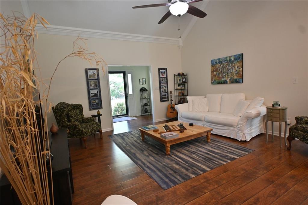 4865 Settles Point Road Suwanee, GA 30024 - Photo 6 of 25 a living room with furniture rug and a chandelier