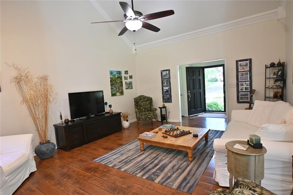 4865 Settles Point Road Suwanee, GA 30024 - Photo 7 of 25 a living room with furniture and a flat screen tv