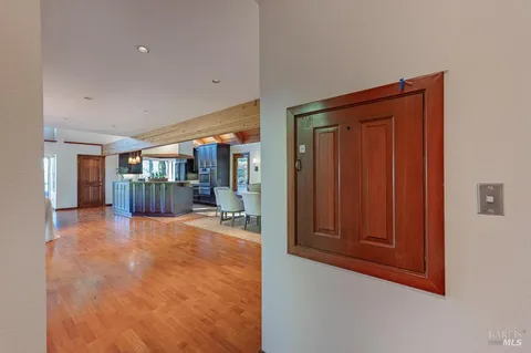 a view of a hallway with wooden shelves