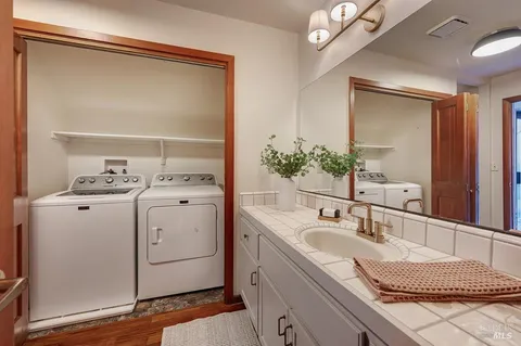 a bathroom with a sink vanity and mirror