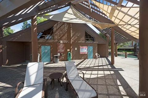 a view of a patio with table and chairs and potted plants