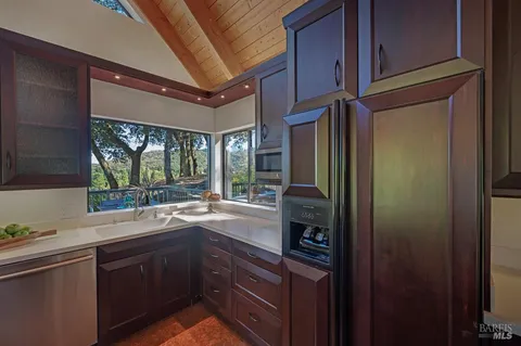 a kitchen with a sink and large cabinets