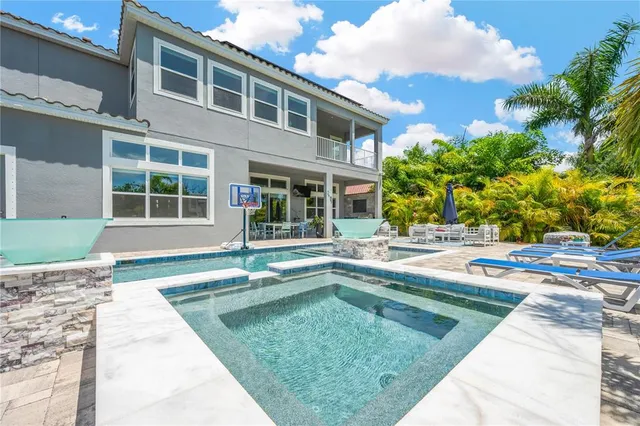 a view of a porch with chairs and potted plants