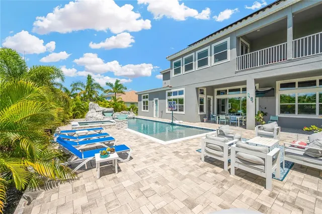 a view of a backyard with sitting area