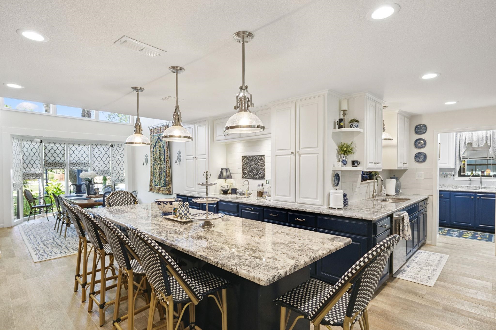 1435 East Zipp Road New Braunfels, TX 78130 - Photo 16 of 43 a dining table with chairs and kitchen view