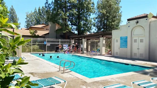 a view of a chair and table in backyard of the house