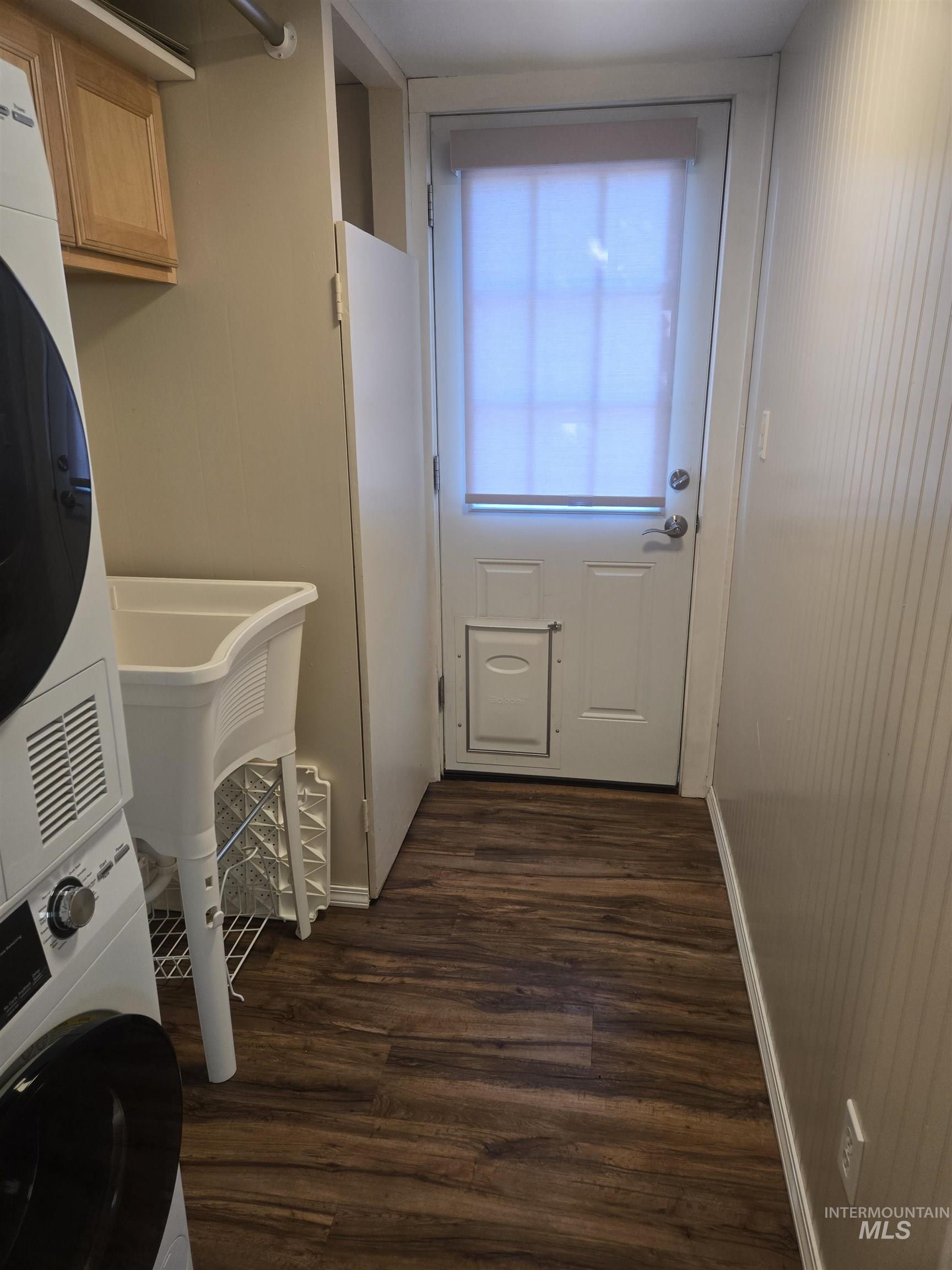 4099 Lakeview Road Orofino, ID 83544 - Photo 10 of 41 Laundry area featuring wood-finish flooring, a utility sink, and wood cabinetry