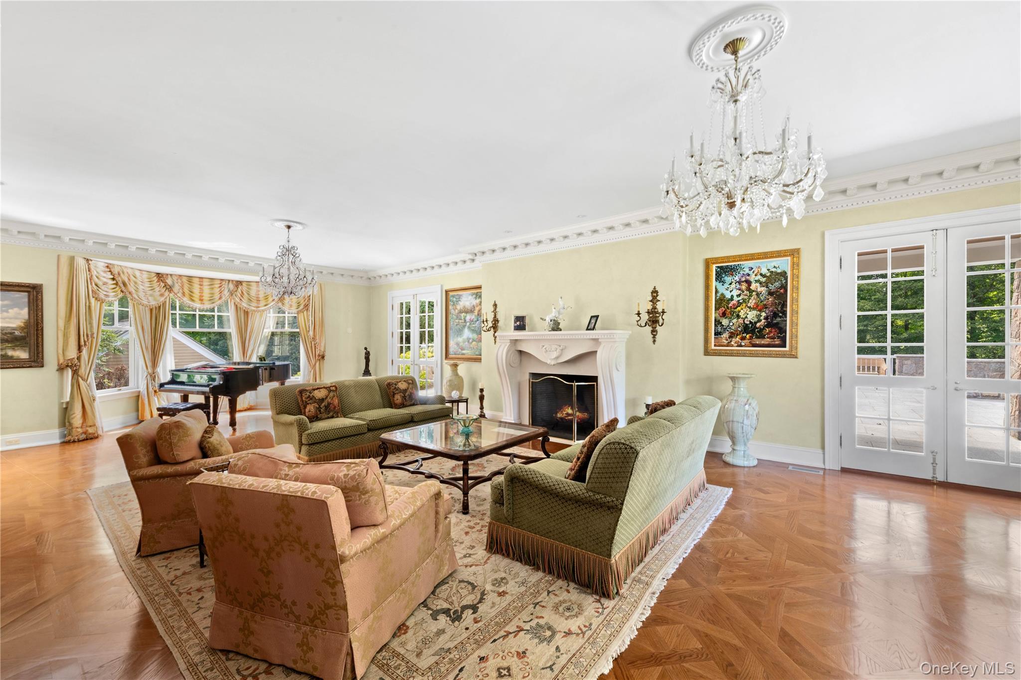 284 West Patent Road Bedford, NY 10549 - Photo 14 of 40 Living room featuring a chandelier, a warm lit fireplace, healthy amount of natural light, and french doors