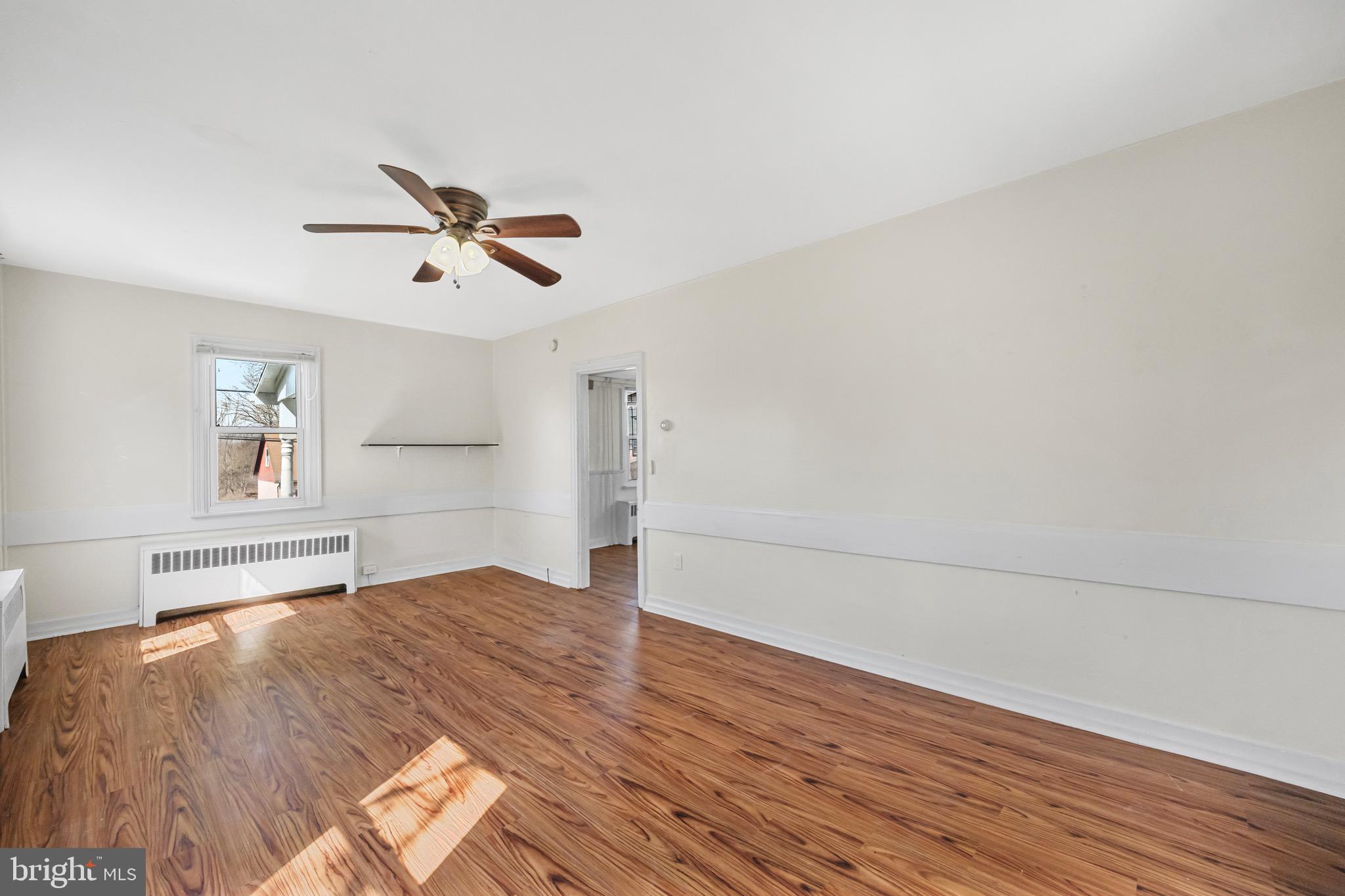 638 State Street Mertztown, PA 19539 - Photo 13 of 25 a view of empty room with wooden floor and fan