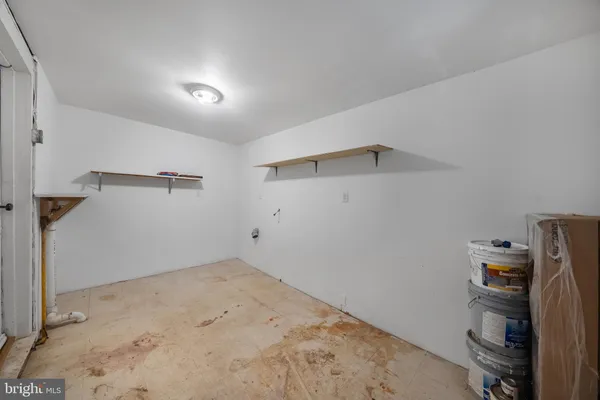 a view of a storage & utility room with a closet
