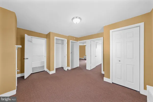 a view of an empty room with closet area