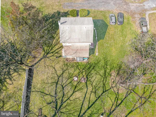 an aerial view of a house with a yard and signage