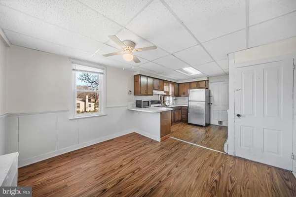 a kitchen with stainless steel appliances granite countertop a lot of counter space and wooden floors