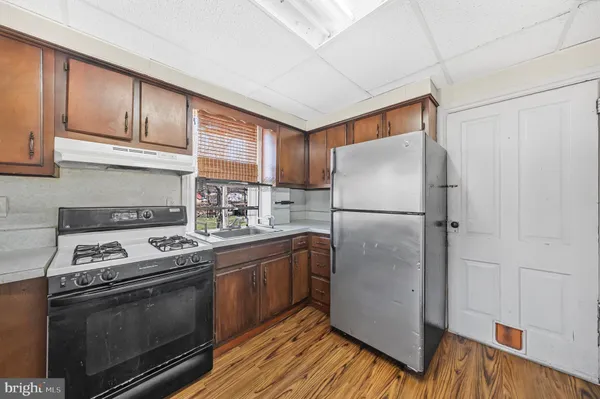 a kitchen with stainless steel appliances granite countertop a stove a refrigerator and a refrigerator