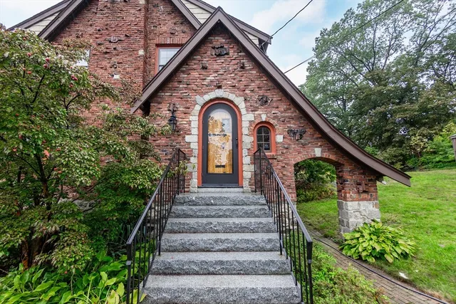 a front view of a house with a garden