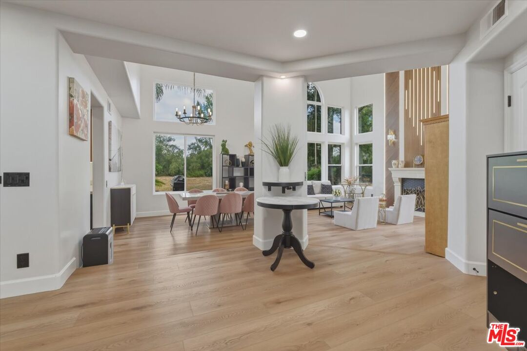 3891 Marks Road Agoura Hills, CA 91301 - Photo 12 of 52 a living room with furniture a dining table and a large window