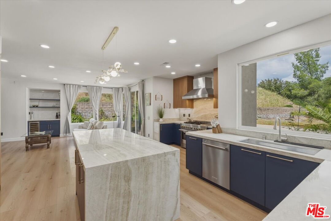 3891 Marks Road Agoura Hills, CA 91301 - Photo 18 of 52 a kitchen with stainless steel appliances granite countertop a sink stove and refrigerator