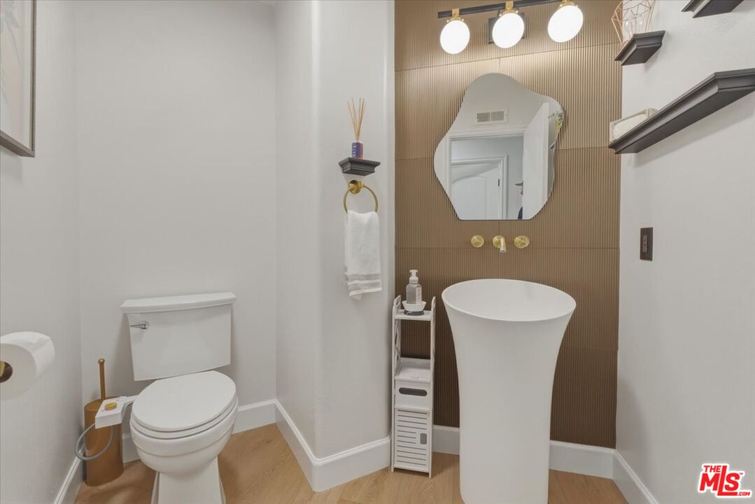 3891 Marks Road Agoura Hills, CA 91301 - Photo 24 of 52 a bathroom with a toilet and a mirror