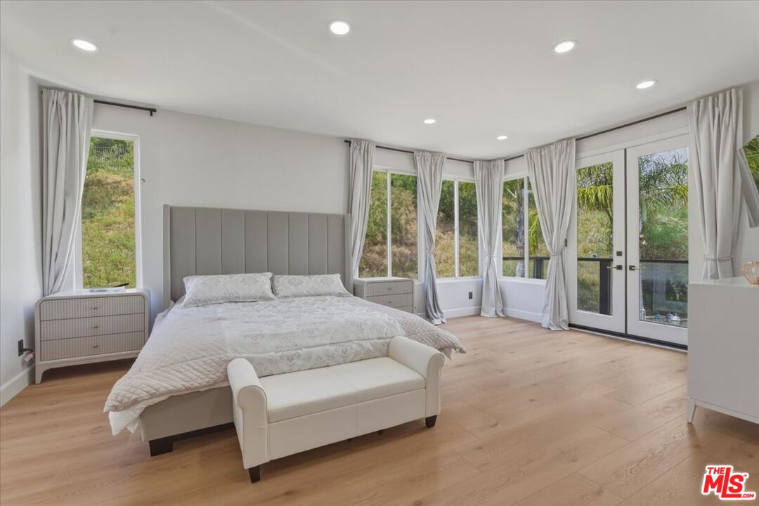 3891 Marks Road Agoura Hills, CA 91301 - Photo 28 of 52 a spacious bedroom with a large bed and a large window