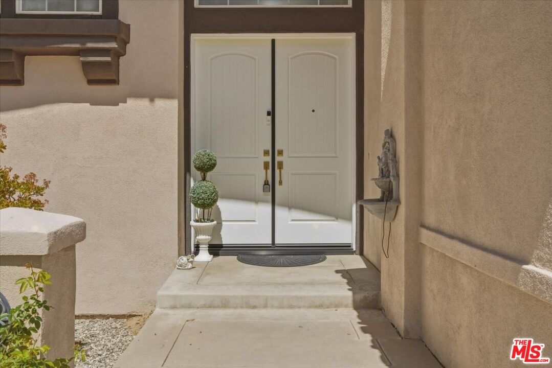 3891 Marks Road Agoura Hills, CA 91301 - Photo 3 of 52 a view of a hallway with wooden floor and a potted plant