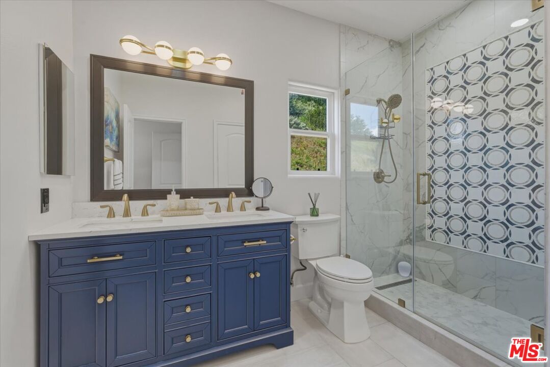 3891 Marks Road Agoura Hills, CA 91301 - Photo 42 of 52 a bathroom with a double vanity sink mirror and toilet