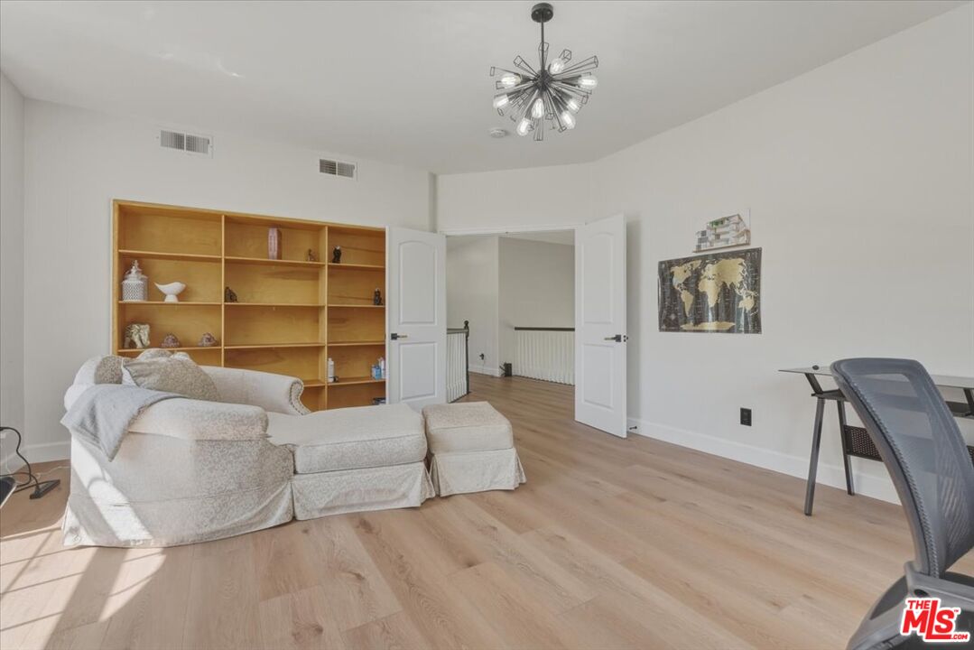 3891 Marks Road Agoura Hills, CA 91301 - Photo 43 of 52 a spacious bedroom with a bed and a chair