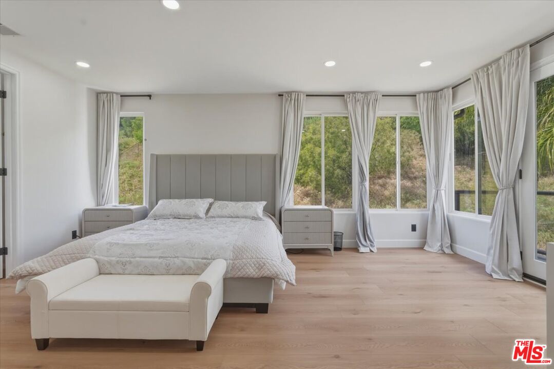 3891 Marks Road Agoura Hills, CA 91301 - Photo 45 of 52 a spacious bedroom with a large bed and a large window
