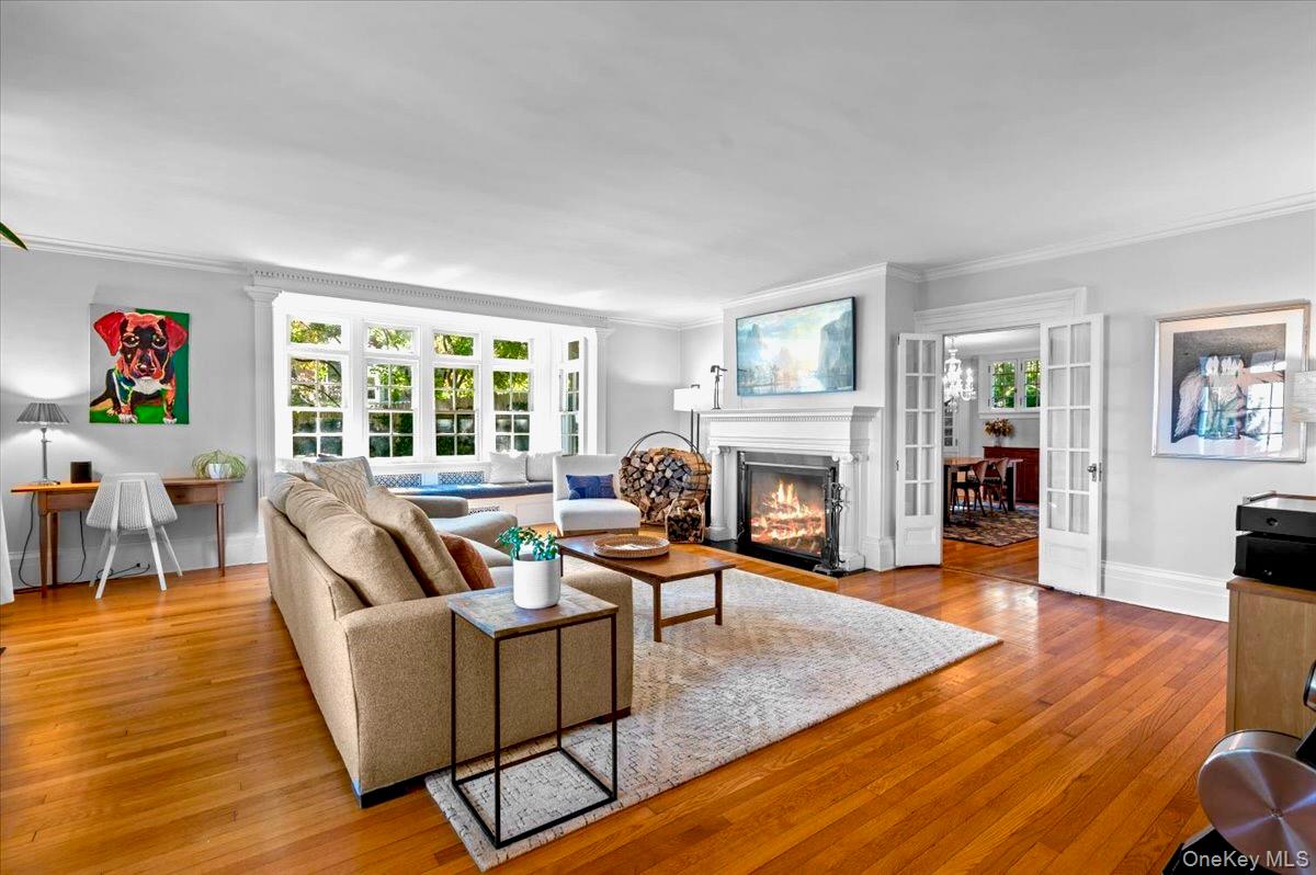 245 River Road Nyack, NY 10960 - Photo 7 of 45 Living area with a fireplace , french doors, light wood-type flooring, and ornamental molding