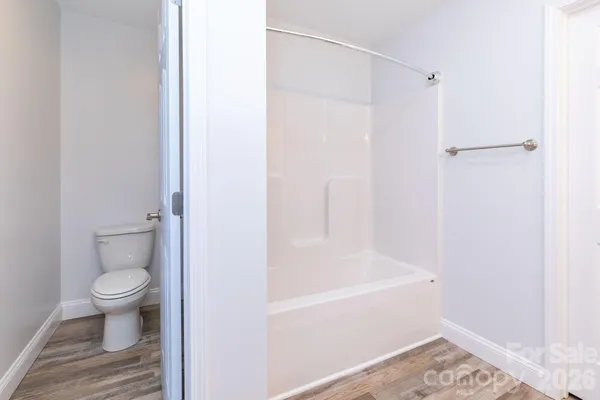a bathroom with a toilet and a shower