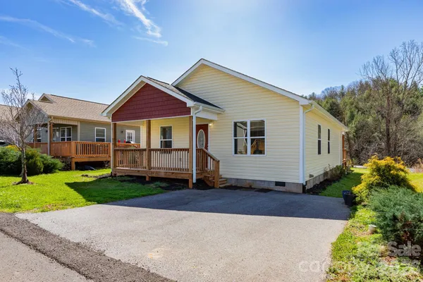 a front view of a house with a yard and porch