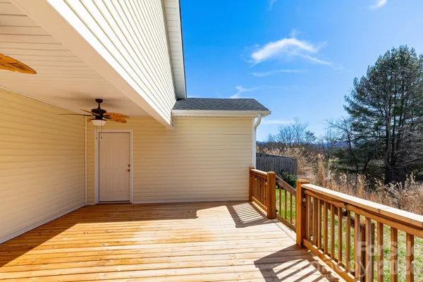 a view of a balcony with wooden floor and lake view