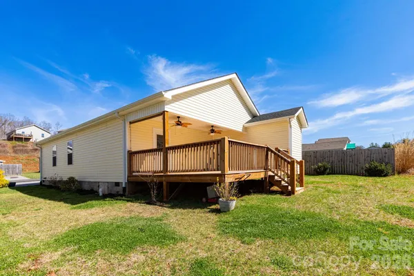 a view of a house with a backyard