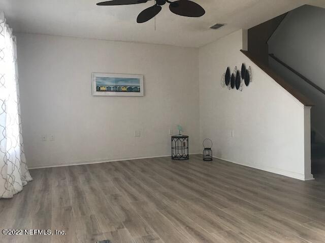 426 Dutton Island Road West Jacksonville, FL 32233 - Photo 14 of 22 a view of an empty room with wooden floor and a window