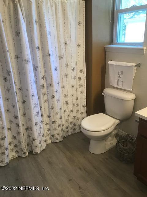 426 Dutton Island Road West Jacksonville, FL 32233 - Photo 18 of 22 a white toilet sitting next to a shower curtain