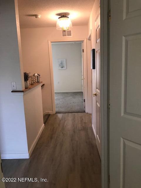426 Dutton Island Road West Jacksonville, FL 32233 - Photo 21 of 22 view of a room with wooden floor and staircase