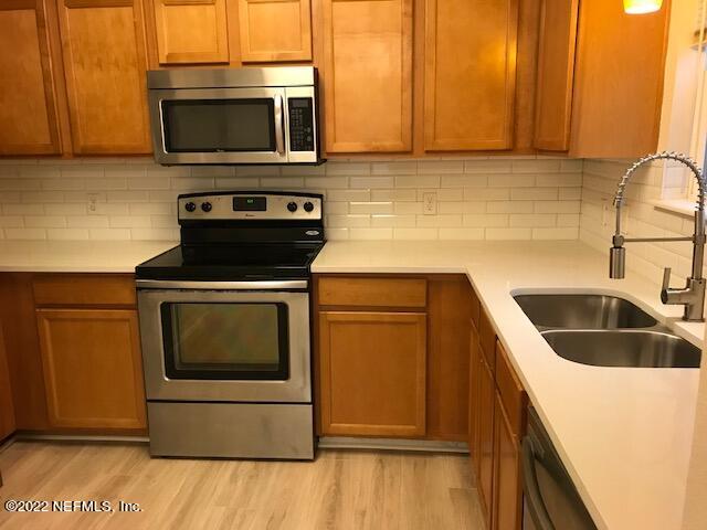426 Dutton Island Road West Jacksonville, FL 32233 - Photo 5 of 22 a kitchen with granite countertop a sink and a stove top oven
