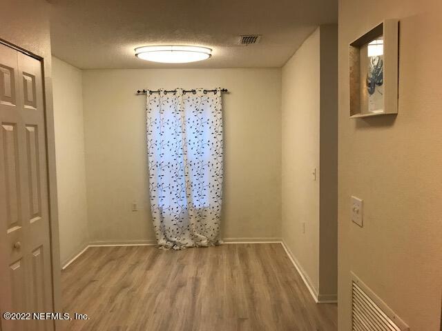 426 Dutton Island Road West Jacksonville, FL 32233 - Photo 9 of 22 a view of empty room with wooden floor