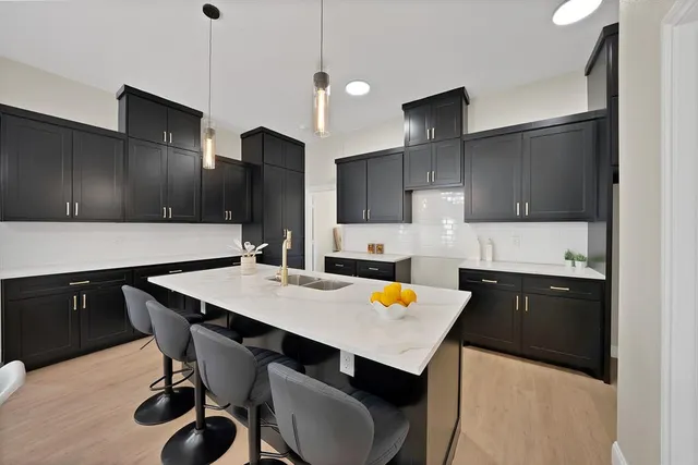 a kitchen with a sink a stove a refrigerator and wooden cabinets