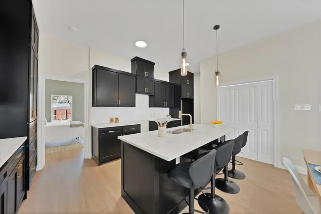 a view of kitchen with cabinets table and chairs
