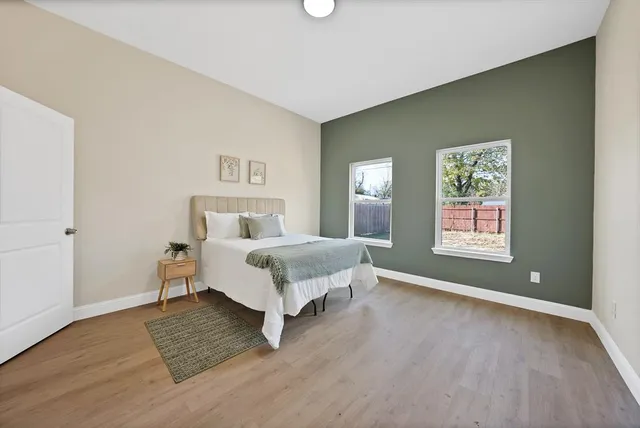 a bedroom with a bed and wooden floor