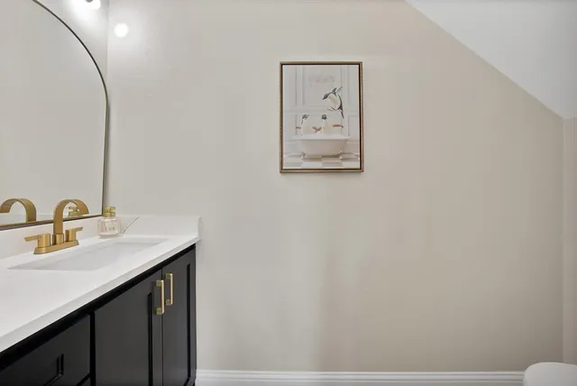 a bathroom with a sink vanity and a mirror