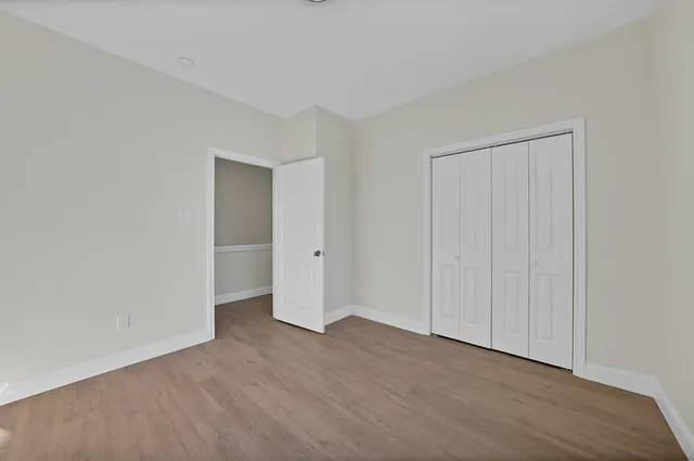a view of an empty room and wooden floor