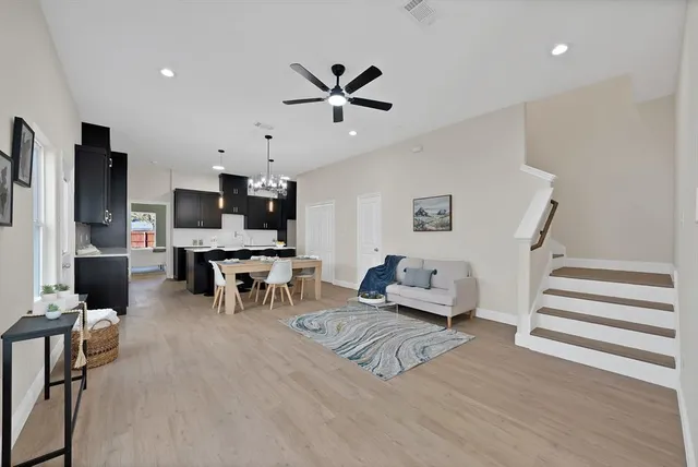 a living room with furniture and kitchen view