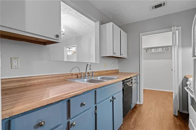 a kitchen with a sink stove and cabinets
