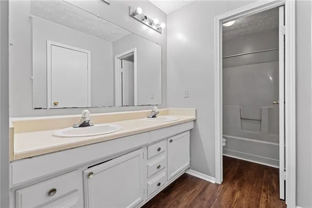 a bathroom with a double vanity sink and mirror