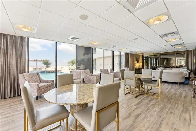 a living room with fireplace furniture and a large window