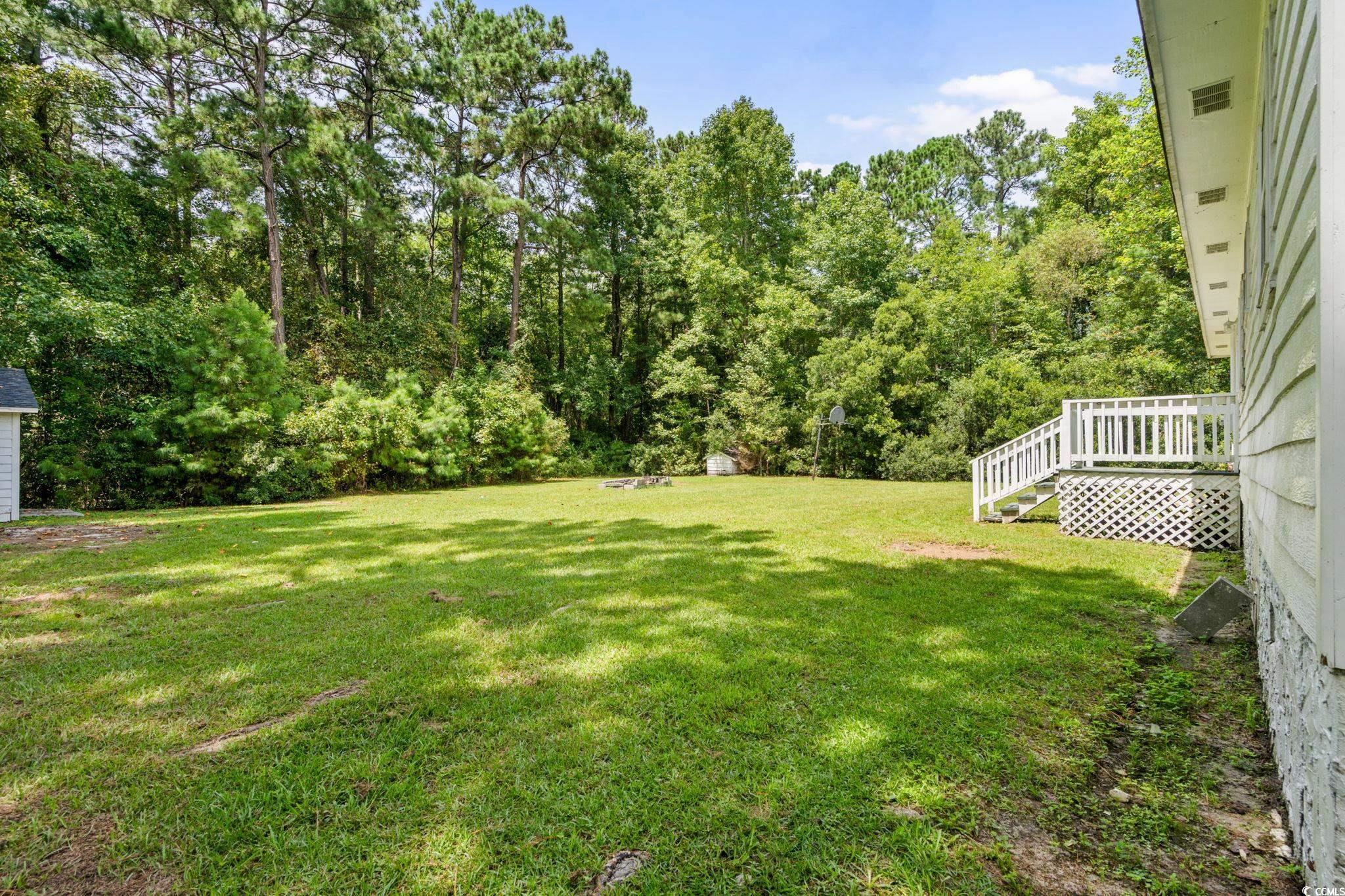450 Highway 348 Loris, SC 29569 - Photo 29 of 37 View of grassy yard featuring a deck