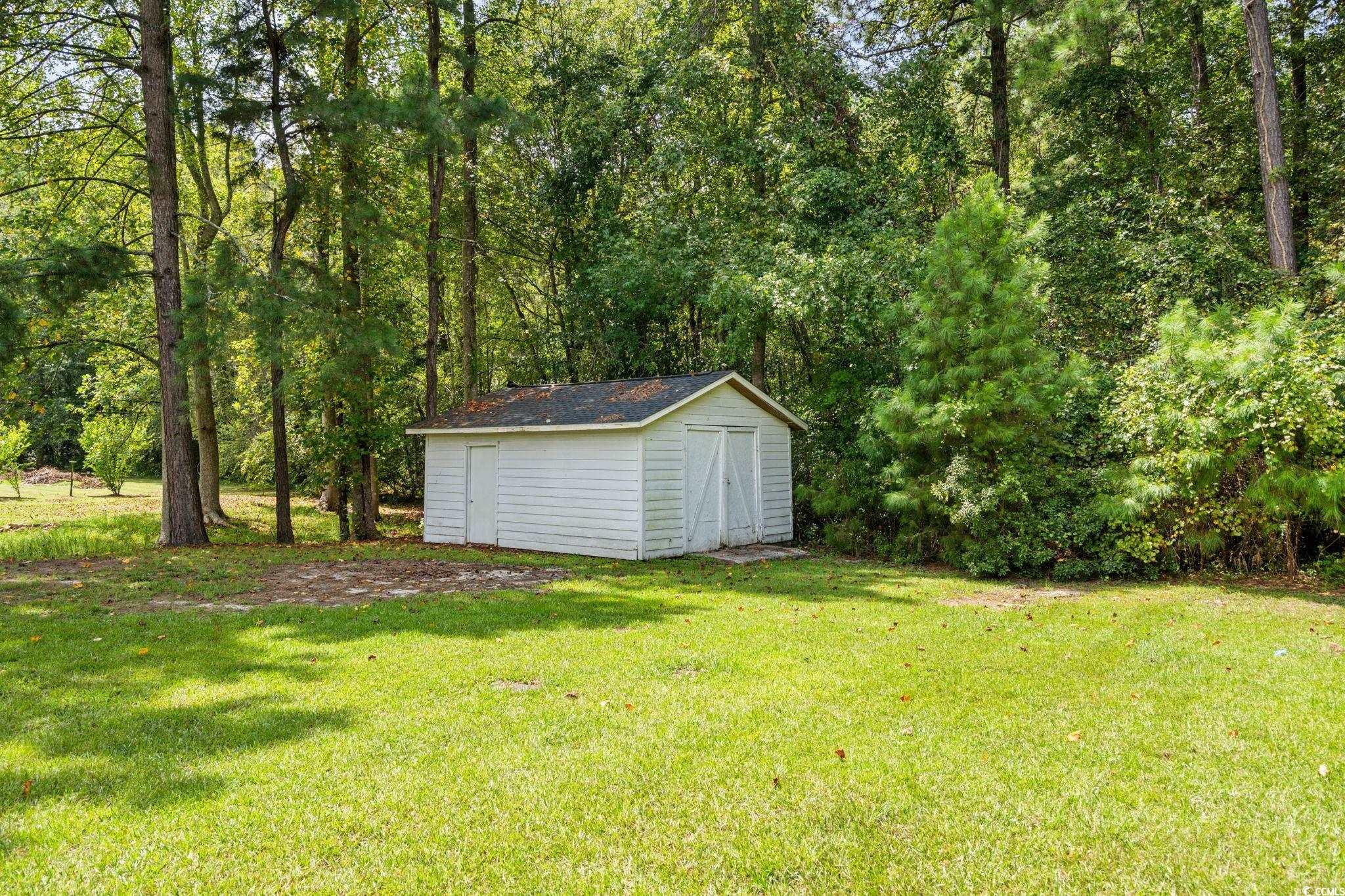 450 Highway 348 Loris, SC 29569 - Photo 30 of 37 View of green lawn with a storage shed