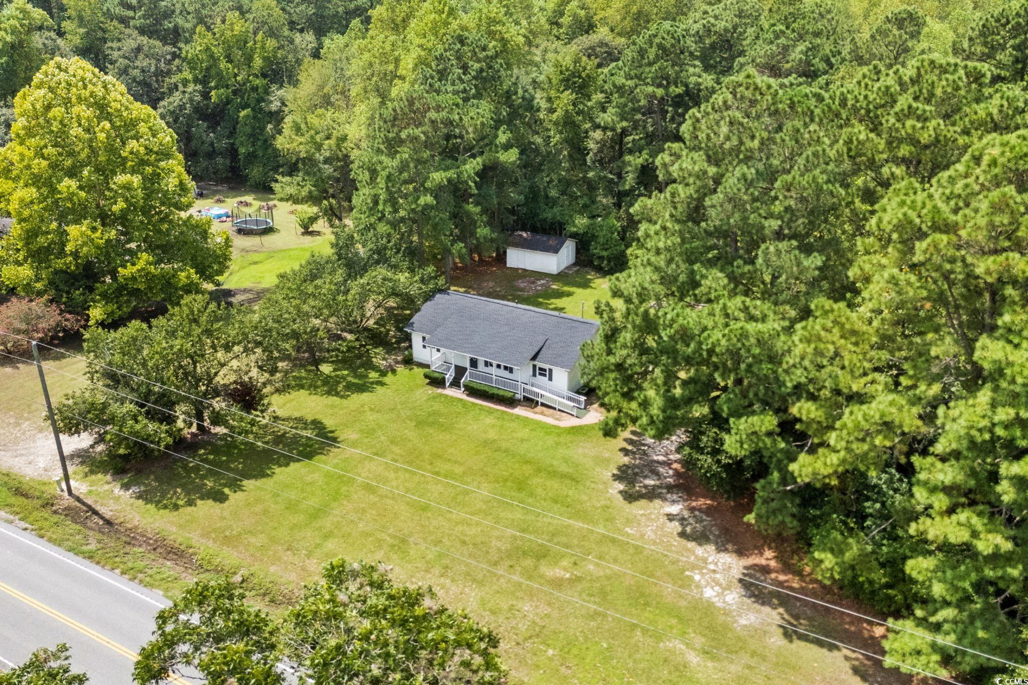 450 Highway 348 Loris, SC 29569 - Photo 32 of 37 Aerial view of property and surrounding area featuring a forest