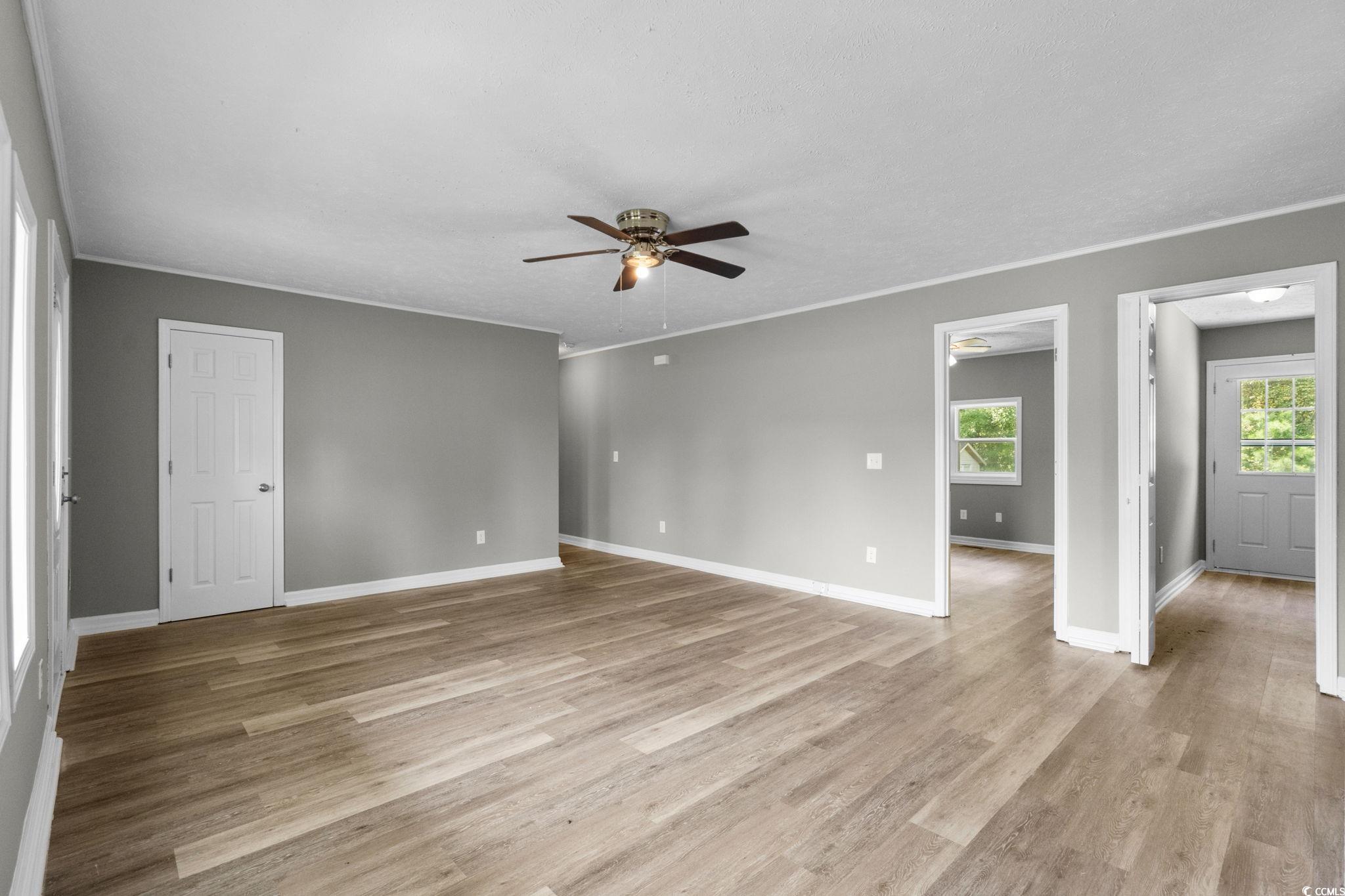 450 Highway 348 Loris, SC 29569 - Photo 8 of 37 Spare room with a ceiling fan, light wood-type flooring, and crown molding